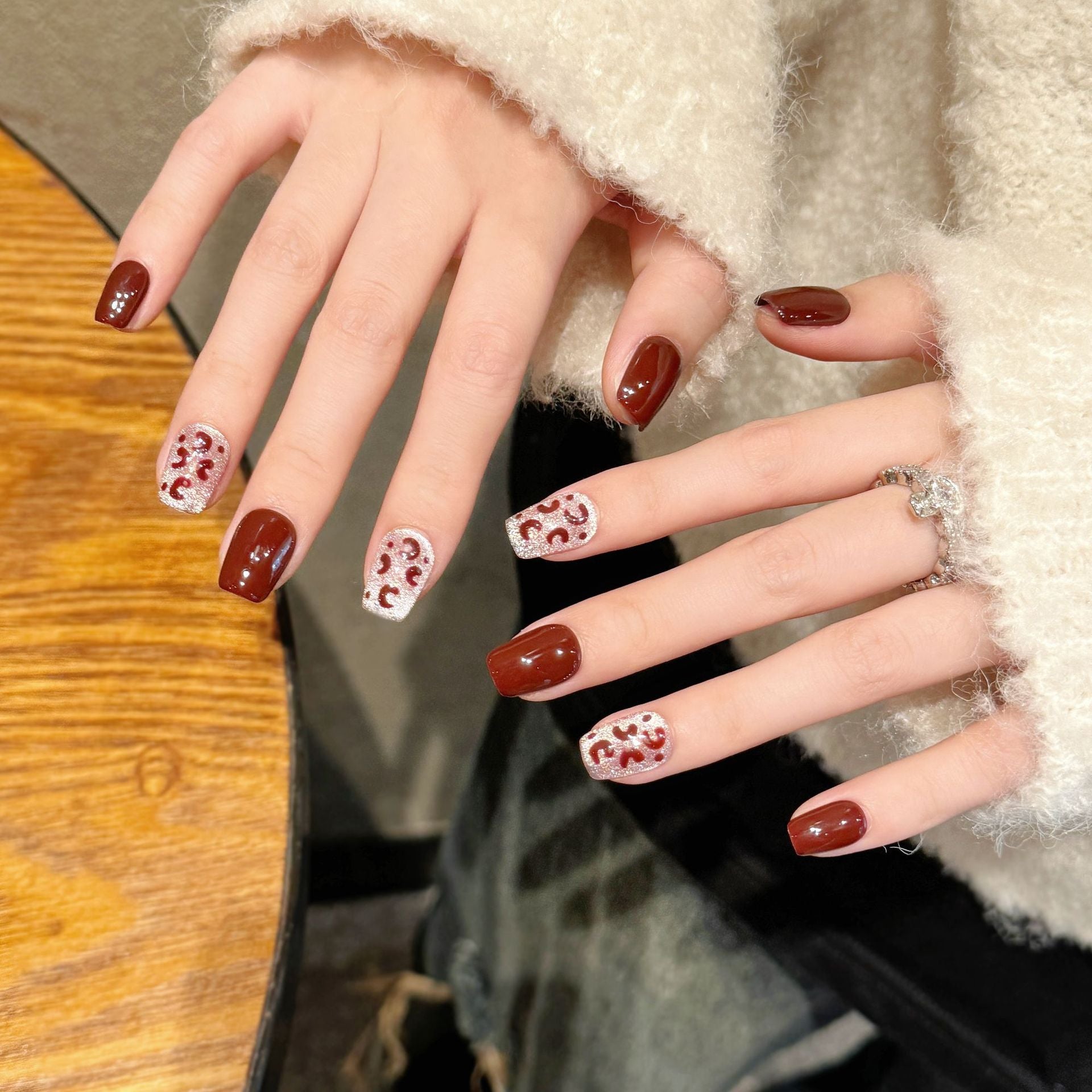 A fashionable party with deep red and silver glittering decorations and nail painting attire