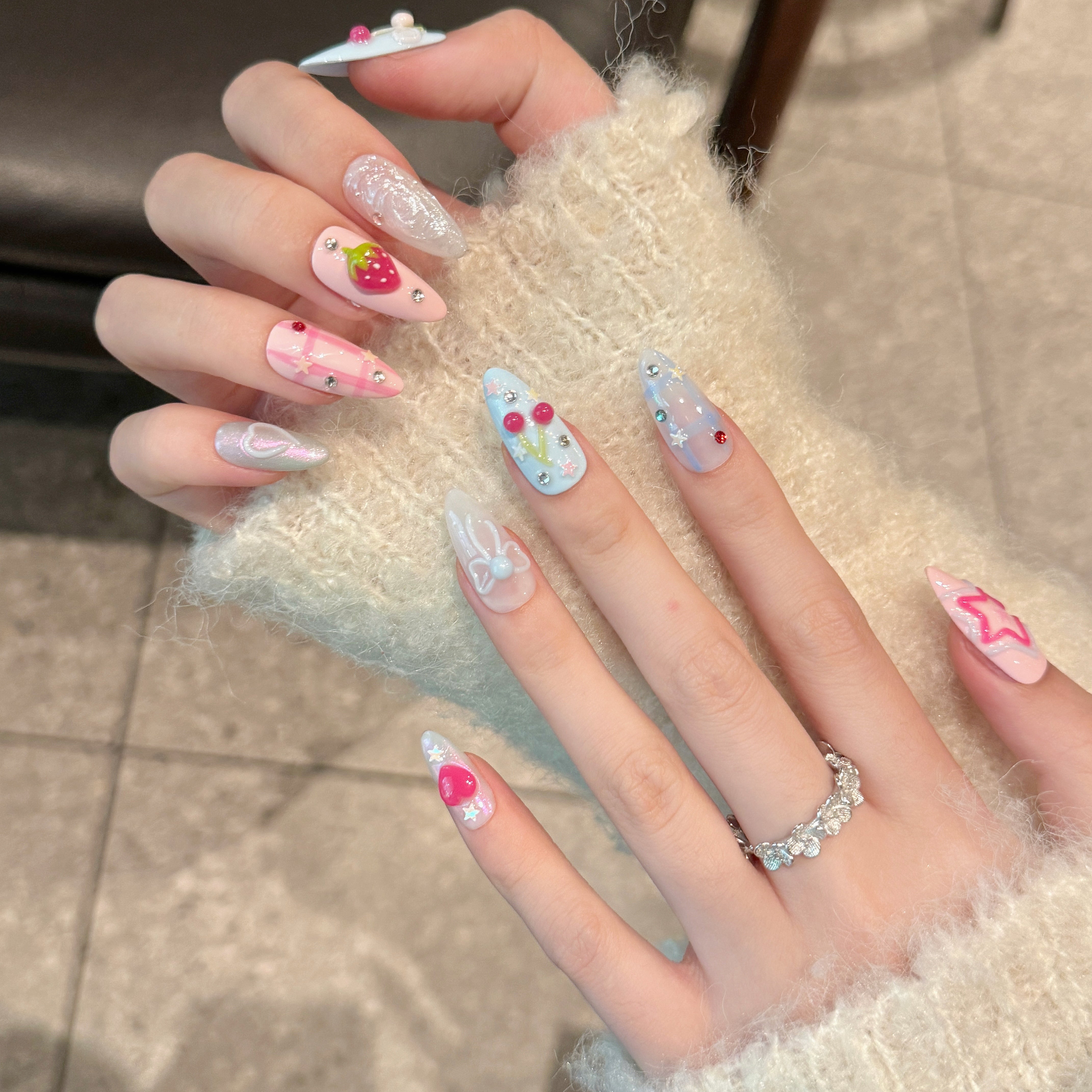 Cute pink and blue fake nails with strawberry patterns