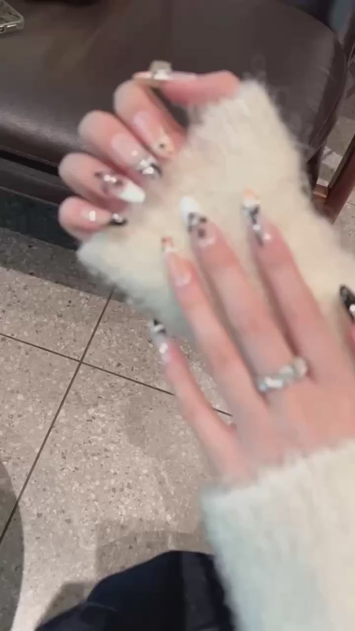 The elegant style of nude and black colors, with floral nail art